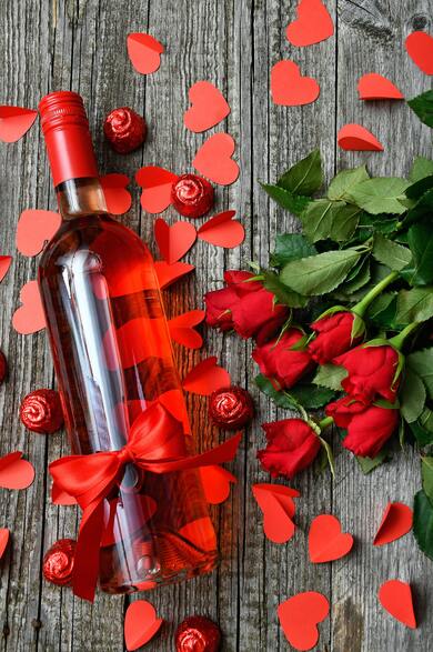 Rose Wine With Red Roses on Wood