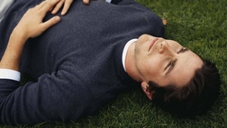 Actor Christian Bale Lying In Garden