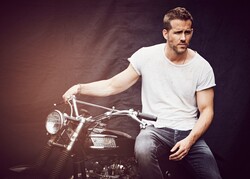 Actor Ryan Reynolds Sitting On Bike
