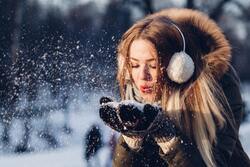 Girl Blowing Ice From Her Hand Wallpaper