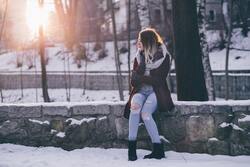 Girl Sitting on Wall in Winters