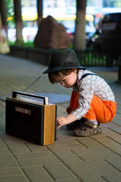 Little Cute Boy Playing Music on Street