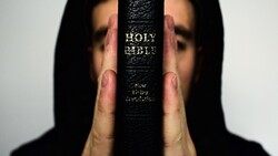 Person Holding Holy Bible Book