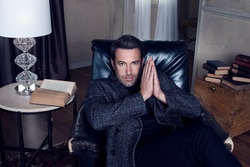 Popular Actor Ben Affleck Sitting On Couch