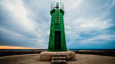 A Green Light House on Beach Upper View