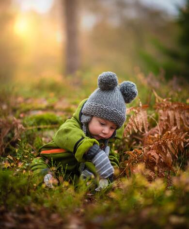 Baby Playing with Leaf in Garden