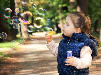 Beauty Kid Playing with Bubbles