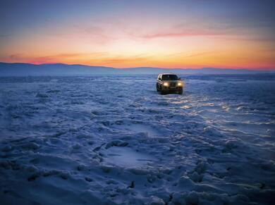 Black SUV Car on Snow During Golden Hour