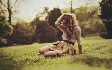 Blonde Girl Resting on Mountain