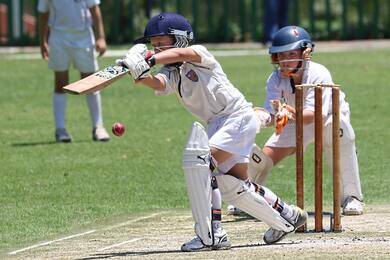 Boys in White Shirt And White Pants Playing Cricket