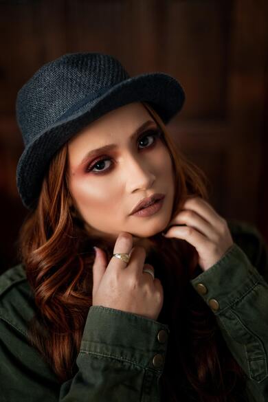 Cute Girl in Green Jacket And Blue Hat