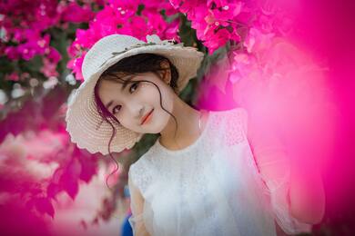 Cute Girl With Pink Flowers in Background