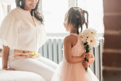 Daughter Giving a Surprise to Mom With Flower