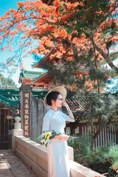 Girl Outside Temple With Flowers in Hand