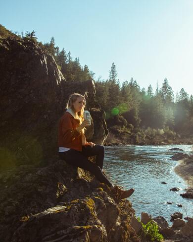 Girl Sitting Beside River