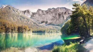 Landscape Photo of Calm Water Between Trees and Mountain