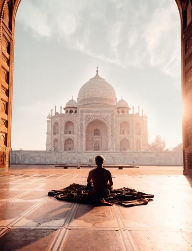 Man Sitting in Front of Taj Mahal