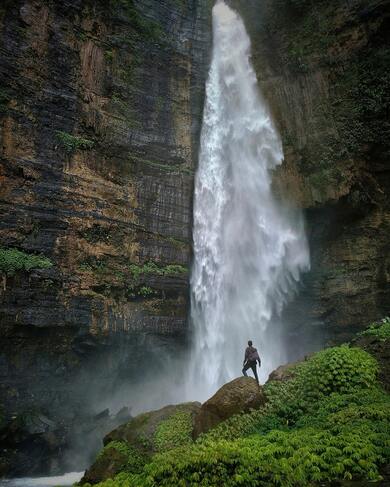 Man Standing Near Big Waterfall