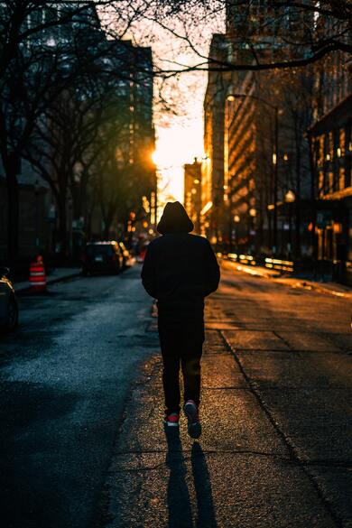 Man Walking Alone in City at Nigh