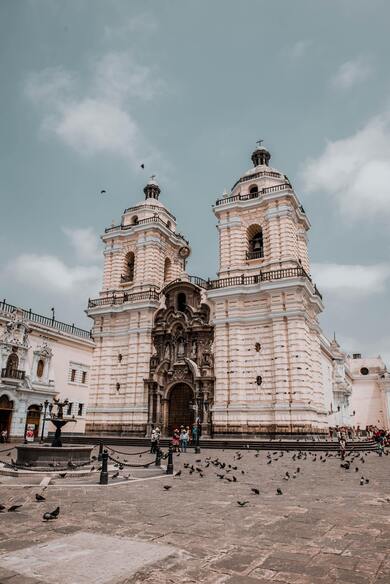 Old Monastery Facade on Square Under Cloudy Sky in Spain