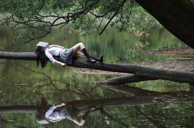 School Girl Sleeping on Tree Over Lake