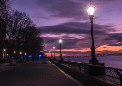 Turned on Street Lamps Beside Bay During Night Time