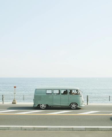 Van Parked Beside The Road Near Handrail And Ocean