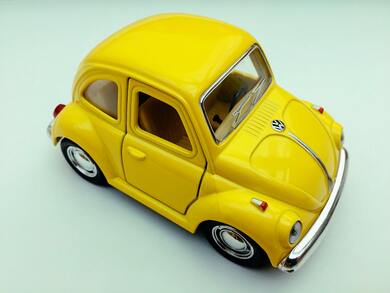 Yellow Volkswagen Beetle Toy Car on White Background