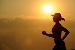 A Woman is Running at Sunset