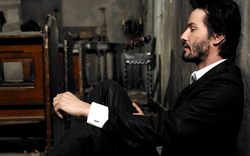 Actor Keanu Reeves Sitting At Ground