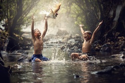 Asian Kids Playing in River Water