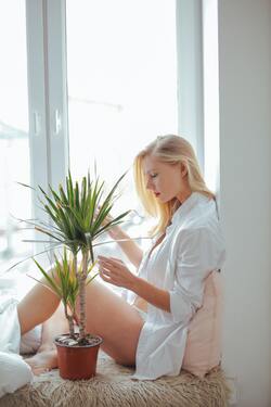 Beautiful Girl Sitting With Plant