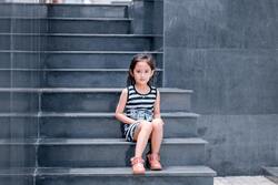 Cute Baby Girl Sitting on Stairs