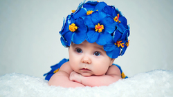 Cute Baby Lying Wearing Violate Flowers In Head 5K Cute Wallpaper