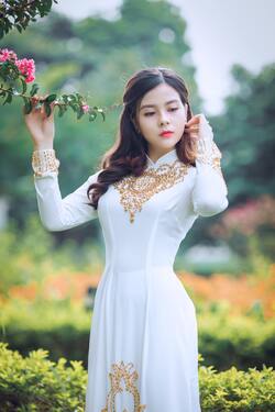 Cute Girl in White Dress in Garden