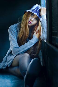 Cute Girl Sitting With Window And Thinking About Someone