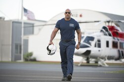 Dwayne Johnson Walking Holding A Helmet In His Hand