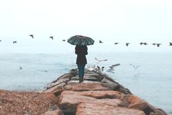 Girl Walking on Sea Rocks