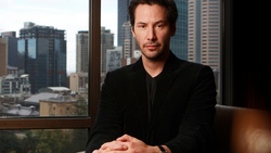 Keanu Reeves Sitting On Chair Near Window