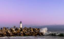 Lighthouse and Boulders in Sea