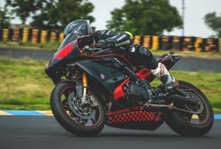 Man Driving a Superbike in Race