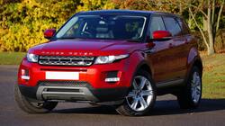 Red Range Rover SUV on Road HD Wallpaper
