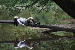 School Girl Sleeping on Tree Over Lake