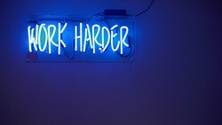 Work Harder Saying in Blue Background